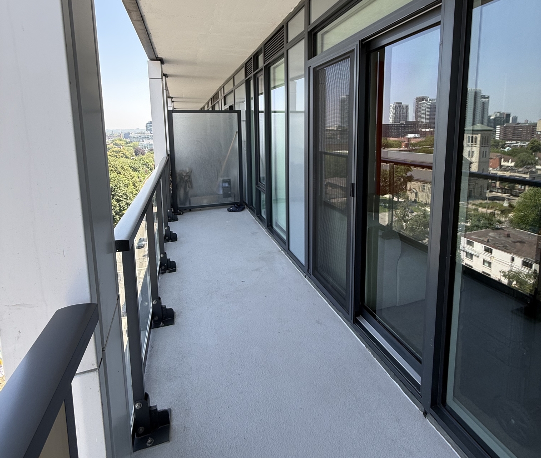 Toronto condo balcony after professional cleaning — spotless glass railing and clean floor
